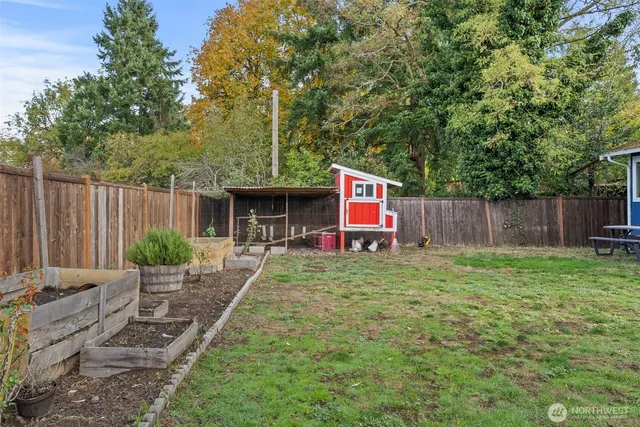 a backyard of a house with table and chairs