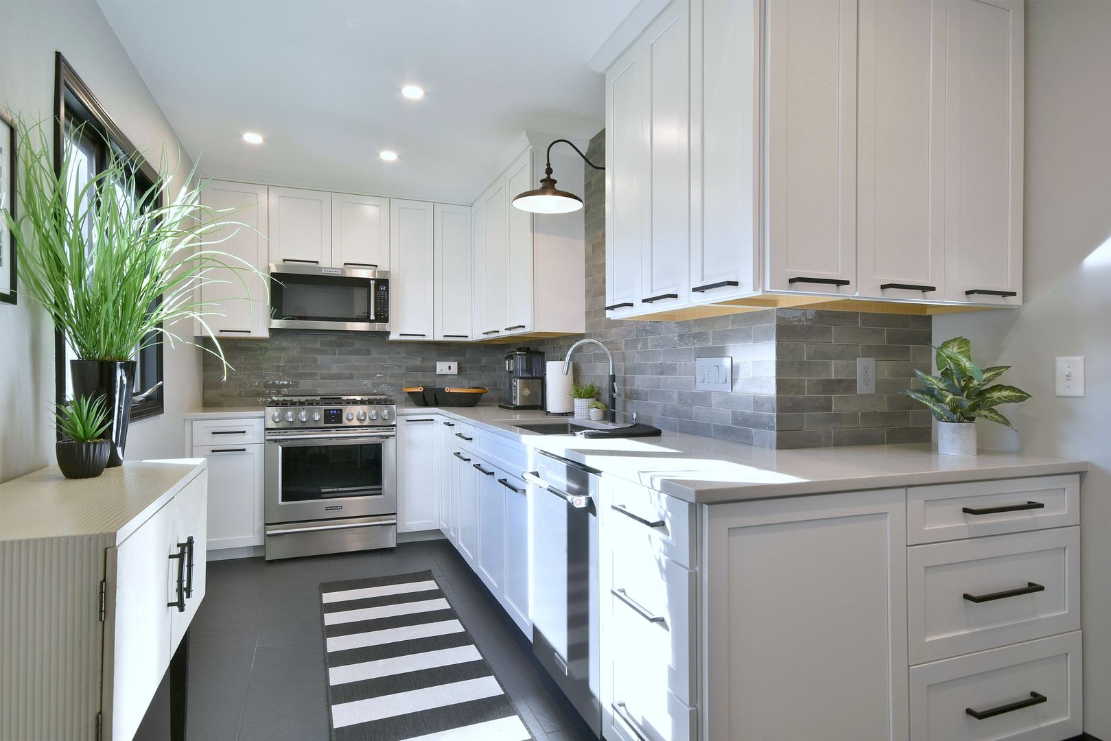 709 Spring Road Elmhurst, IL 60126 - Photo 13 of 42 a kitchen with kitchen island granite countertop appliances cabinets and a potted plant