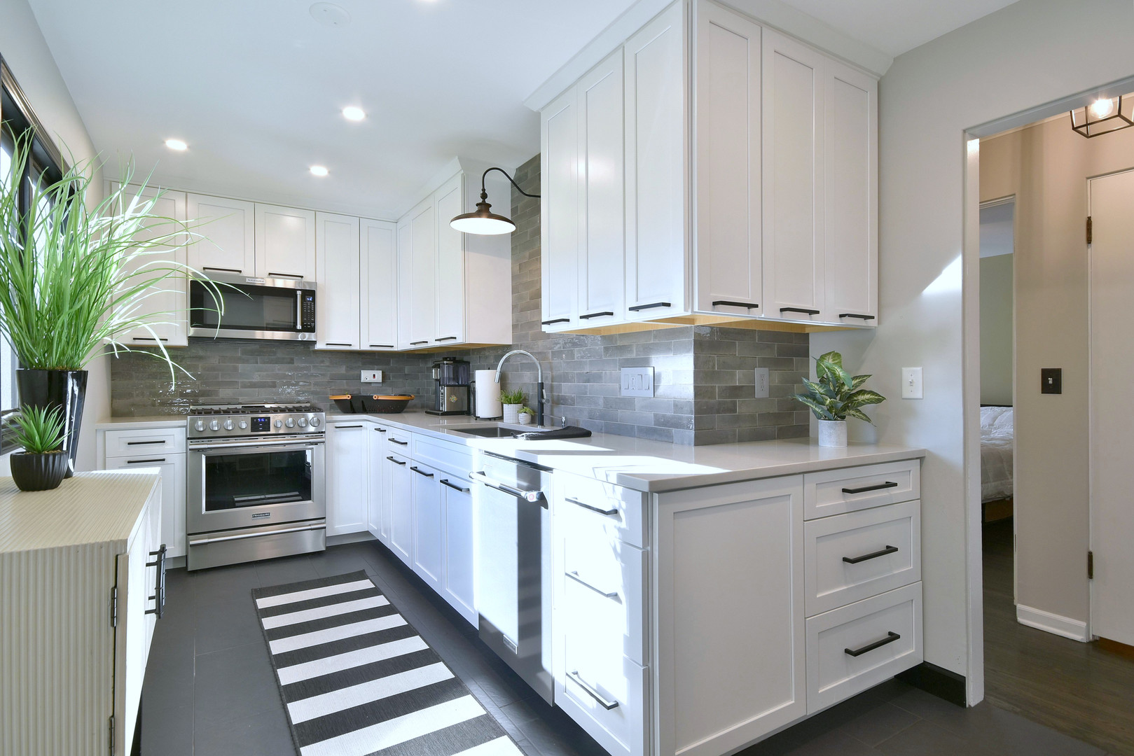 709 Spring Road Elmhurst, IL 60126 - Photo 14 of 42 a kitchen with white cabinets and white appliances