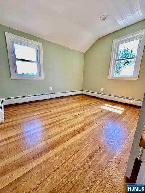3 MacArthur Avenue Hasbrouck Heights, NJ 07604 - Photo 6 of 15 a view of an empty room with wooden floor and a window