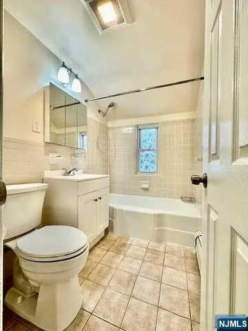 a bathroom with a sink toilet vanity and bathtub