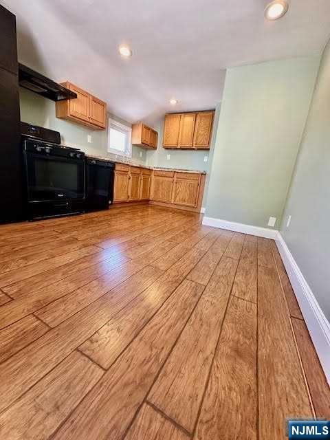 3 MacArthur Avenue Hasbrouck Heights, NJ 07604 - Photo 10 of 15 a view of a kitchen with kitchen island a sink wooden floor and stainless steel appliances
