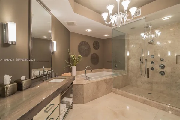 a bathroom with a double vanity sink mirror and shower