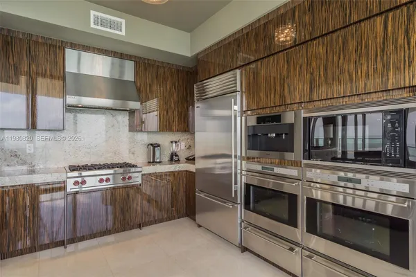 a kitchen with stainless steel appliances granite countertop a stove and a sink