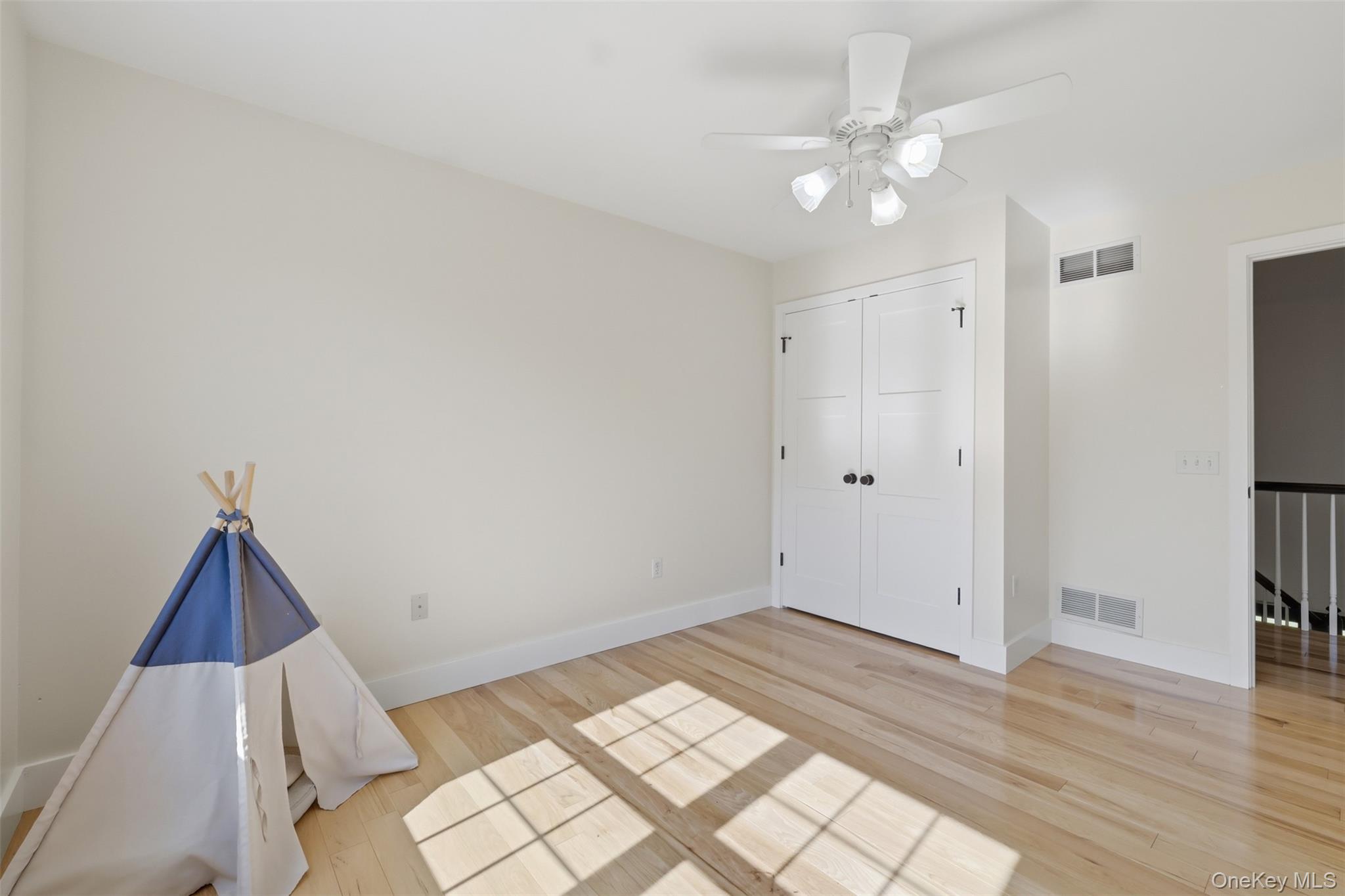 233 Devon Farms Road Stormville, NY 12582 - Photo 35 of 48 a view of a room with wooden floor and white walls
