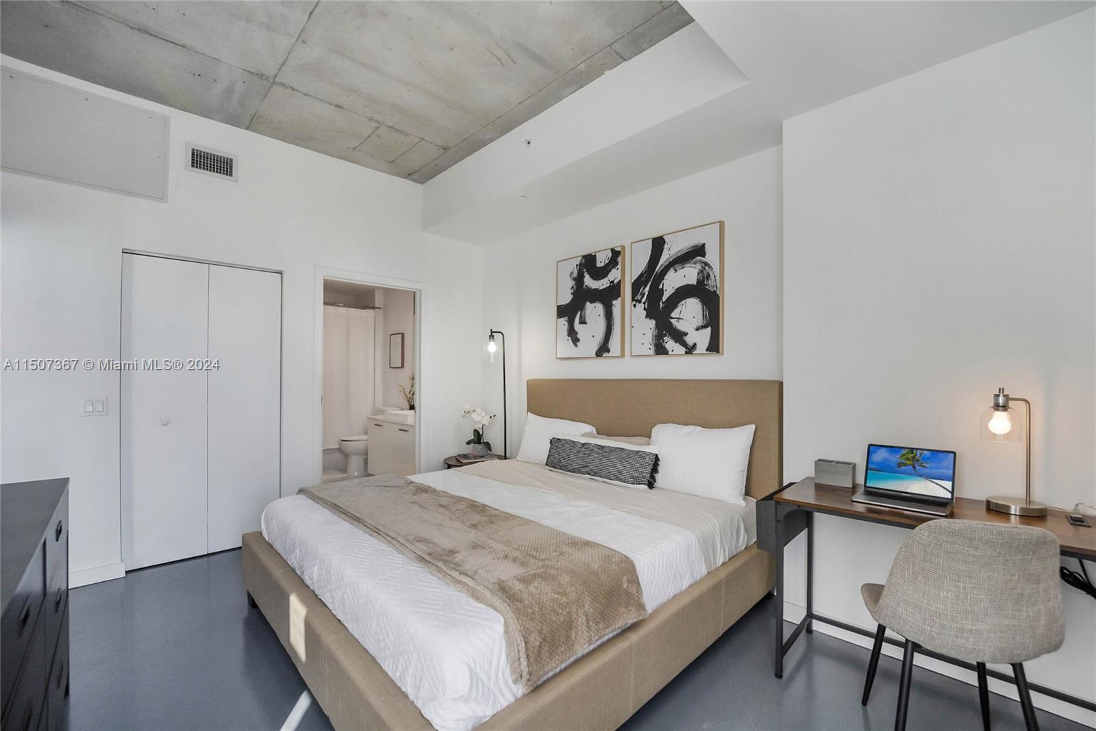 151 Southeast 1st Street, Unit 2109 Miami, FL 33131 - Photo 8 of 13 a bedroom with a bed and a desk