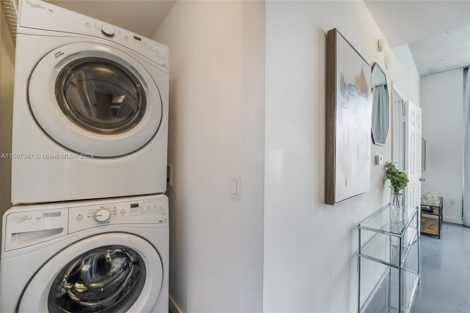 151 Southeast 1st Street, Unit 2109 Miami, FL 33131 - Photo 10 of 13 a view of a hallway with washer and dryer