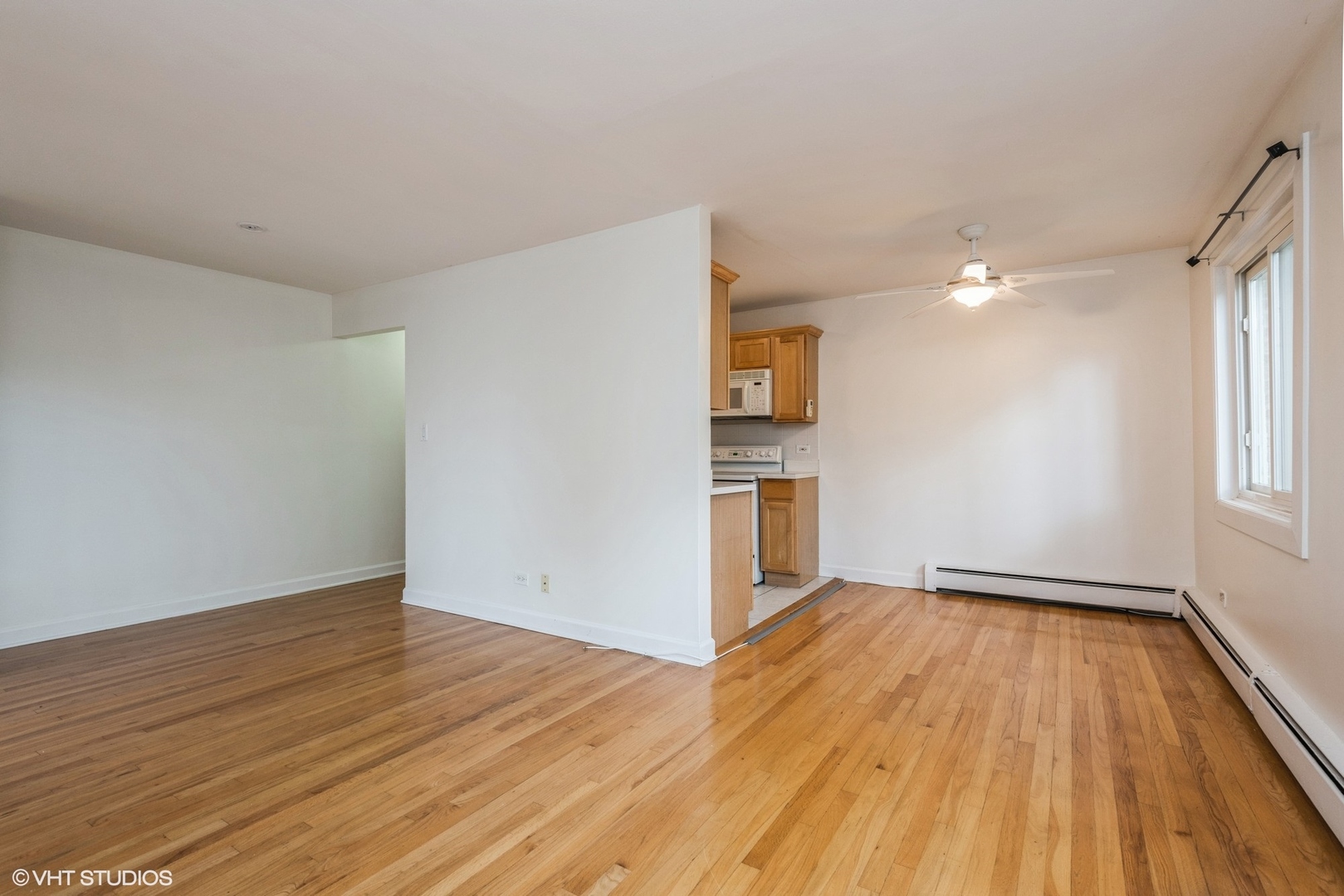 820 Seward Street, Unit 3E Evanston, IL 60202 - Photo 11 of 24 a view of empty room with wooden floor and window