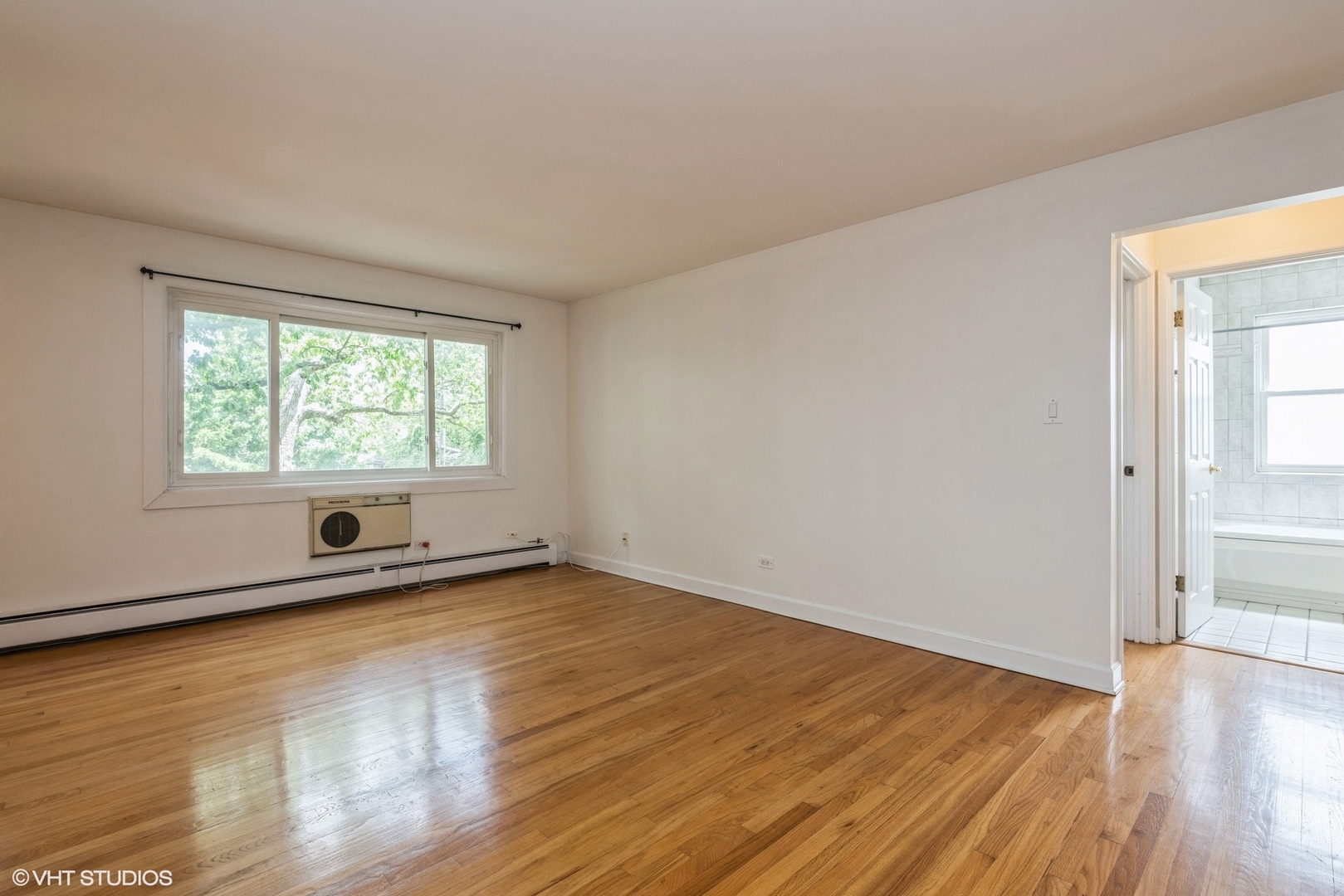 820 Seward Street, Unit 3E Evanston, IL 60202 - Photo 13 of 24 an empty room with wooden floor and windows