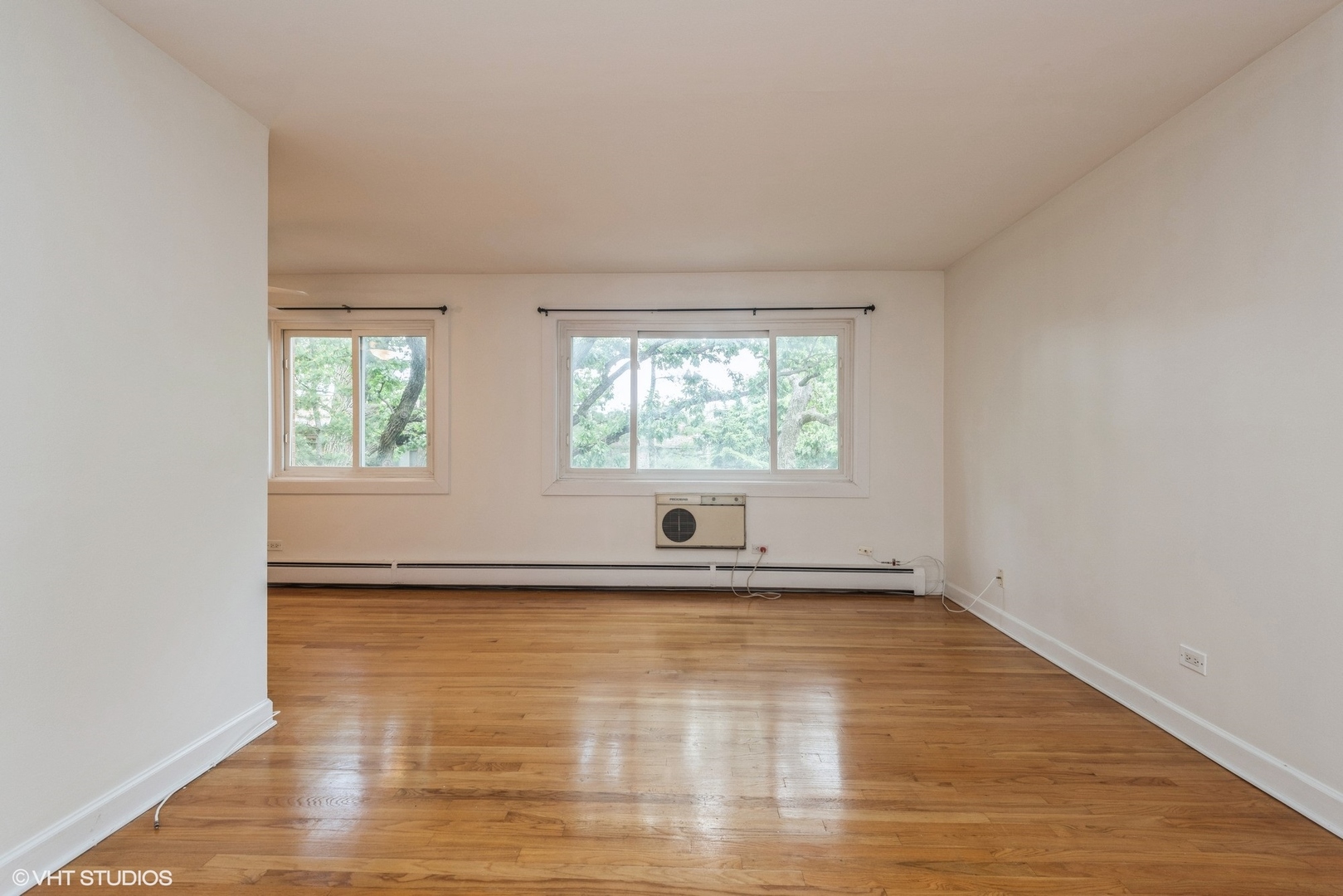 820 Seward Street, Unit 3E Evanston, IL 60202 - Photo 14 of 24 wooden floor in an empty room with a window