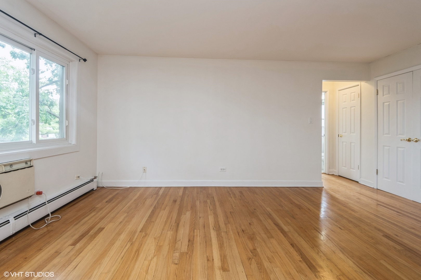 820 Seward Street, Unit 3E Evanston, IL 60202 - Photo 16 of 24 an empty room with wooden floor and windows