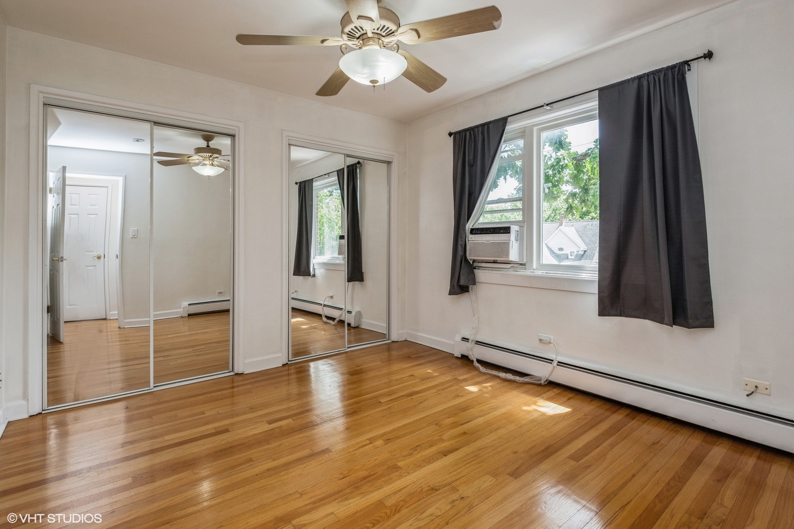 820 Seward Street, Unit 3E Evanston, IL 60202 - Photo 17 of 24 wooden floor in an empty room with a window