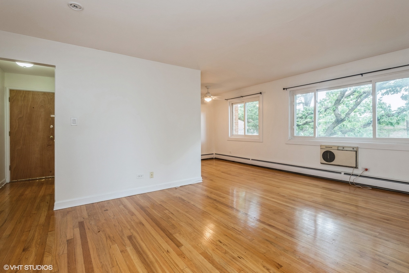 820 Seward Street, Unit 3E Evanston, IL 60202 - Photo 2 of 24 an empty room with wooden floor and windows