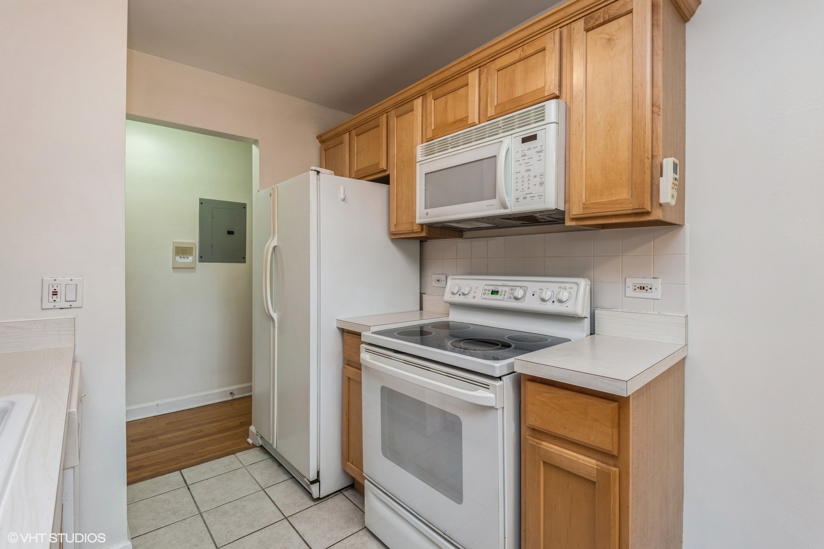 820 Seward Street, Unit 3E Evanston, IL 60202 - Photo 5 of 24 a kitchen with white cabinets and stainless steel appliances