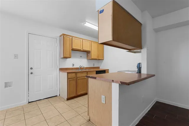a kitchen with stainless steel appliances granite countertop a sink and a stove