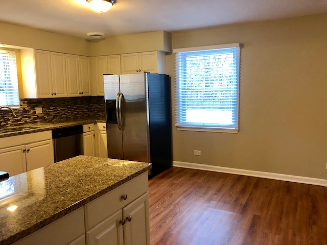 40 Valley Road Glen Ellyn, IL 60137 - Photo 11 of 24 a kitchen with granite countertop wooden floors and stainless steel appliances