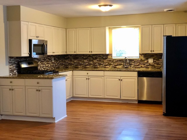 40 Valley Road Glen Ellyn, IL 60137 - Photo 14 of 24 a kitchen with stainless steel appliances granite countertop a stove a sink and a microwave