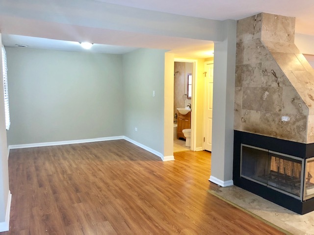 40 Valley Road Glen Ellyn, IL 60137 - Photo 4 of 24 a view of an empty room with wooden floor and a fireplace