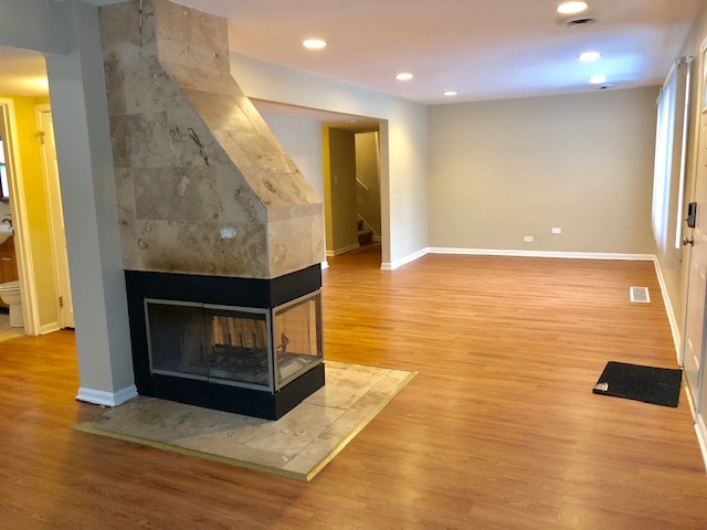 40 Valley Road Glen Ellyn, IL 60137 - Photo 5 of 24 a view of an empty room with wooden floor and a fireplace