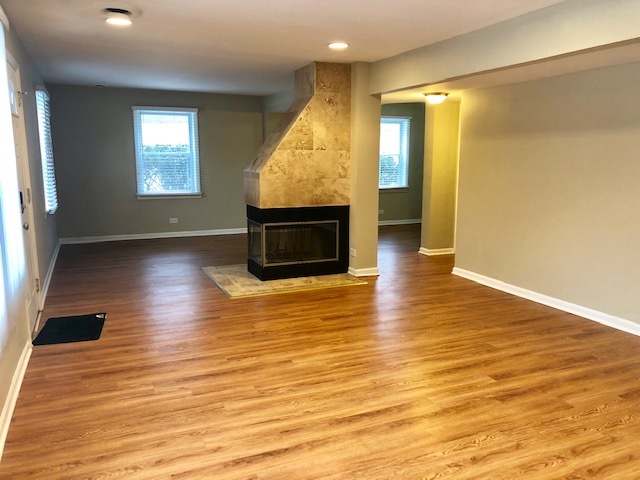 40 Valley Road Glen Ellyn, IL 60137 - Photo 7 of 24 wooden floor in an empty room with a fireplace