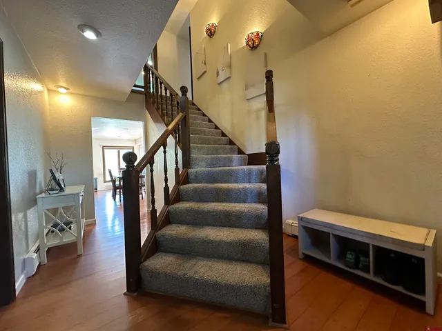 a living room with furniture and stairs