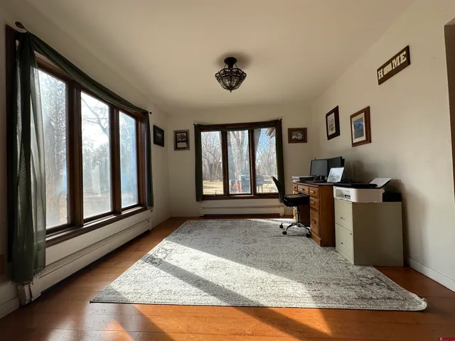 a living room with furniture rug and a window