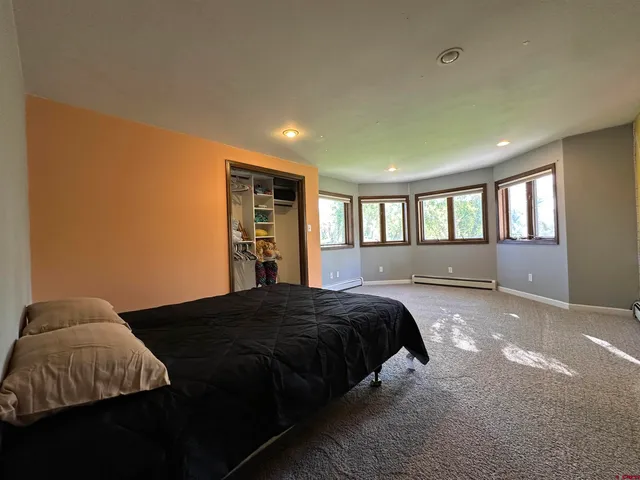 a bedroom with a bed and window