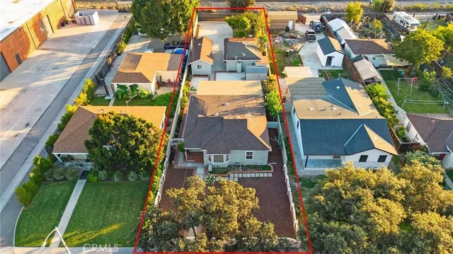 an aerial view of a house with a yard and garden