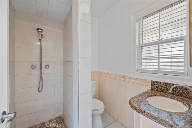 an empty room with windows and ceiling fan