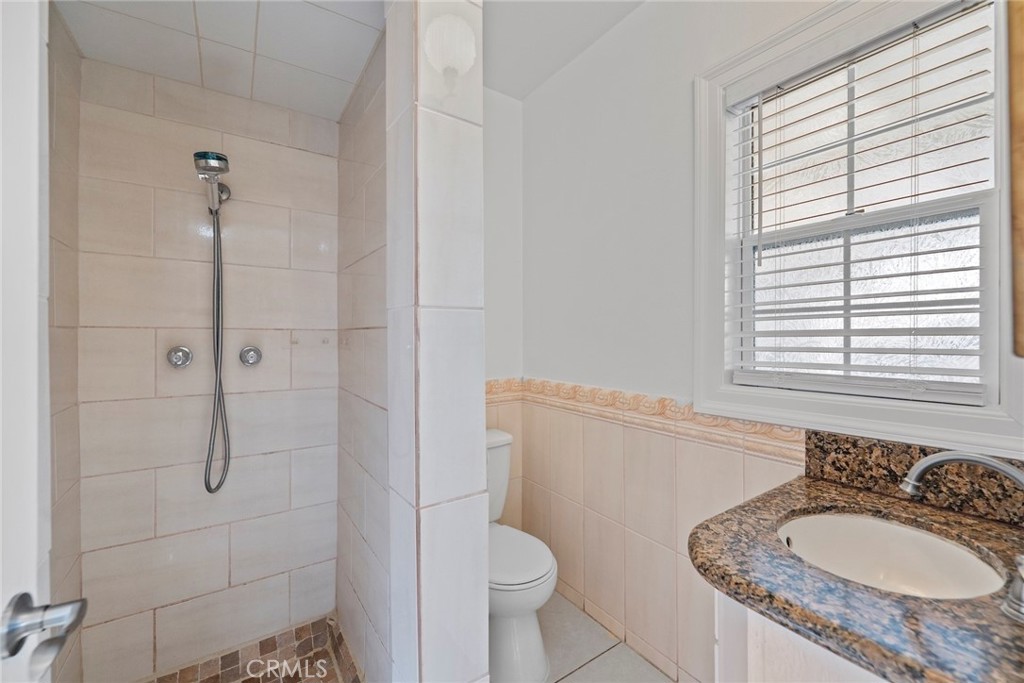 1104 Williamson Avenue Fullerton, CA 92833 - Photo 46 of 75 a bathroom with a granite countertop sink toilet and shower
