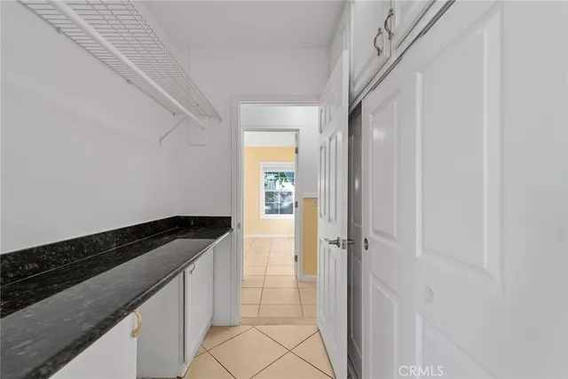 an empty room with large windows and a livingroom