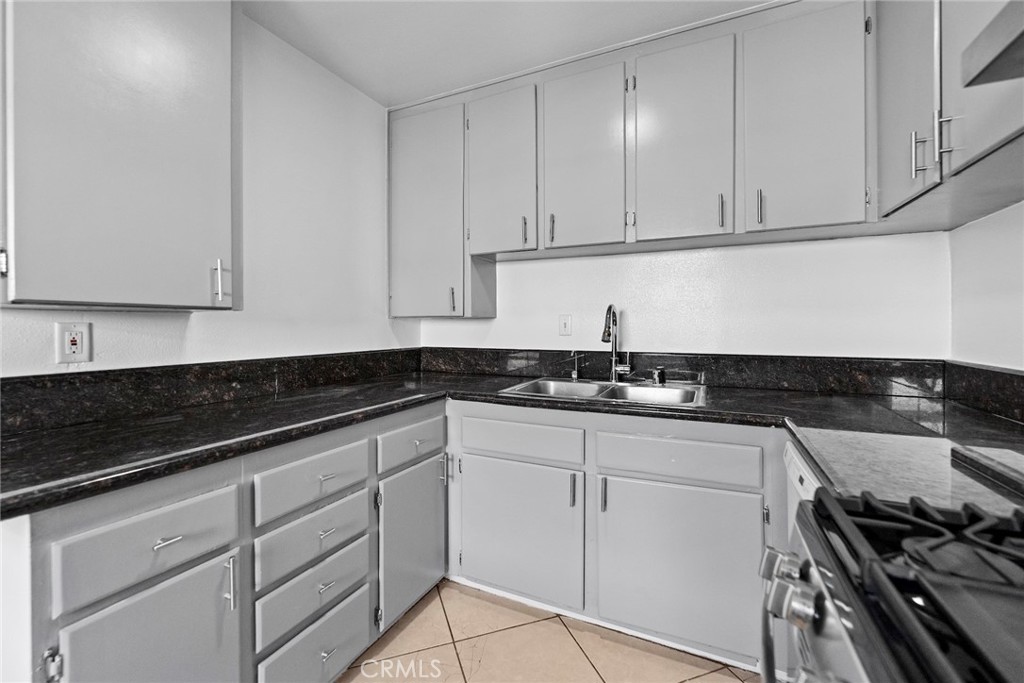 1104 Williamson Avenue Fullerton, CA 92833 - Photo 55 of 75 a kitchen with granite countertop white cabinets and a stove