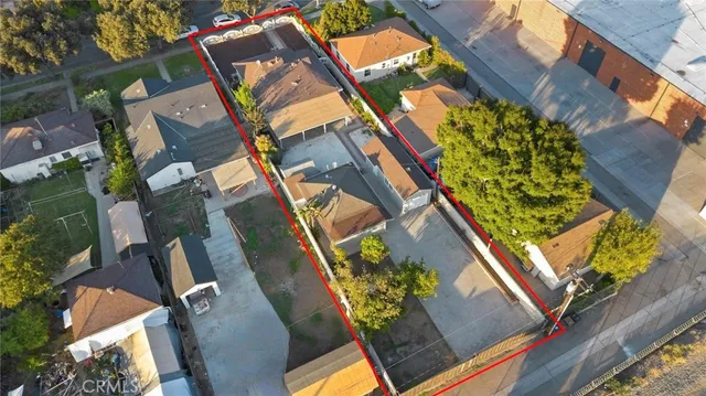 an aerial view of residential houses with city view