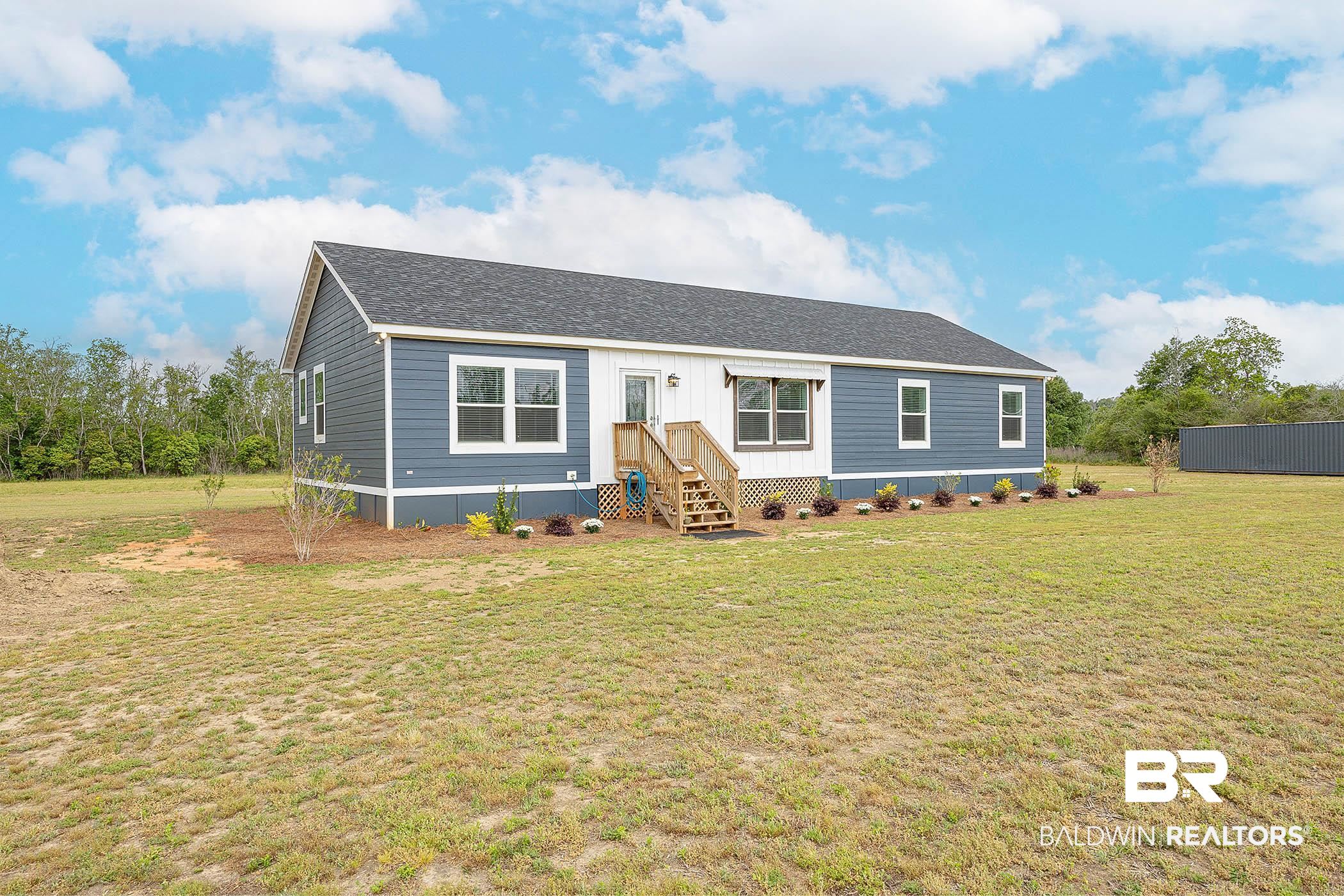 16000 John Bauer Road Summerdale, AL 36580 - Photo 4 of 34 Manufactured / mobile home featuring entry steps, a front lawn, and roof with shingles