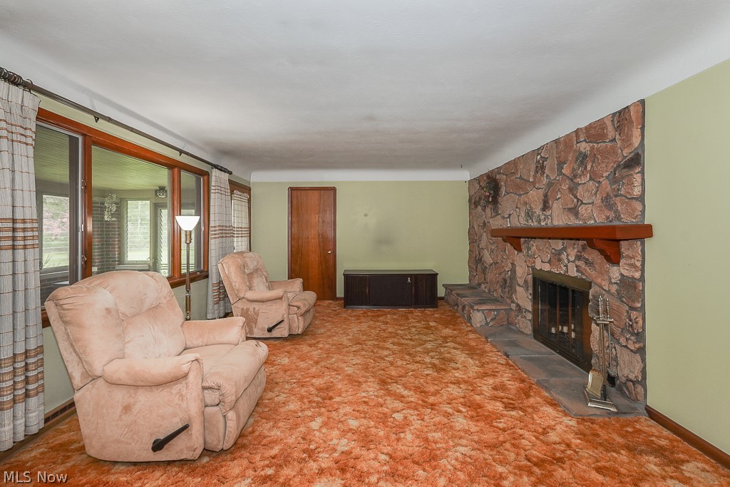 13028 Root Road Columbia Station, OH 44028 - Photo 10 of 35 Carpeted living room with a stone fireplace