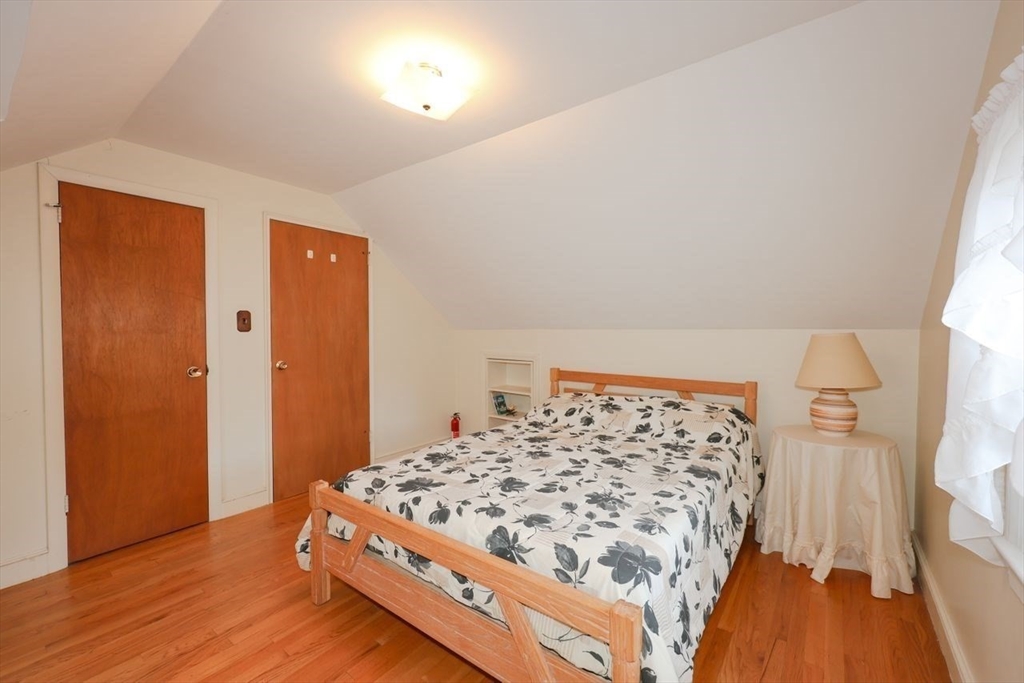 35 Walnut Road Chelmsford, MA 01824 - Photo 23 of 42 a bedroom with a bed and a wooden floor