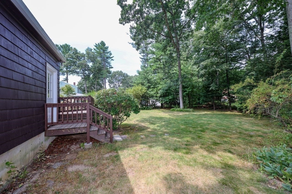 35 Walnut Road Chelmsford, MA 01824 - Photo 32 of 42 a view of a backyard with wooden fence and large trees