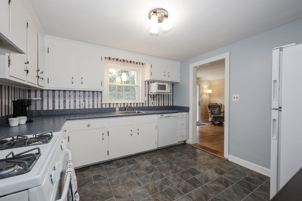 35 Walnut Road Chelmsford, MA 01824 - Photo 6 of 42 a kitchen with a stove a sink and a refrigerator