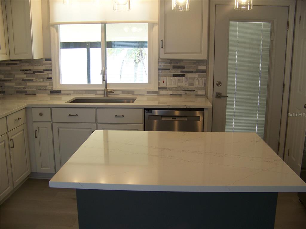 15550 Burnt Store Road, Unit 202 Punta Gorda, FL 33955 - Photo 12 of 61 a kitchen with stainless steel appliances a refrigerator sink and window