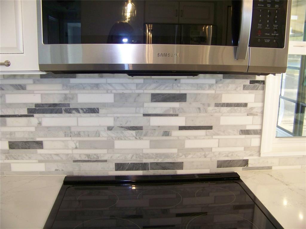 15550 Burnt Store Road, Unit 202 Punta Gorda, FL 33955 - Photo 20 of 61 a kitchen with a sink and cabinets