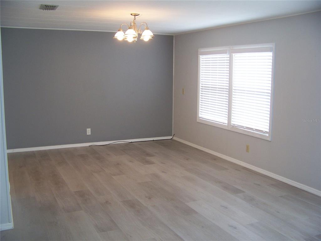 15550 Burnt Store Road, Unit 202 Punta Gorda, FL 33955 - Photo 25 of 61 wooden floor in an empty room with a window