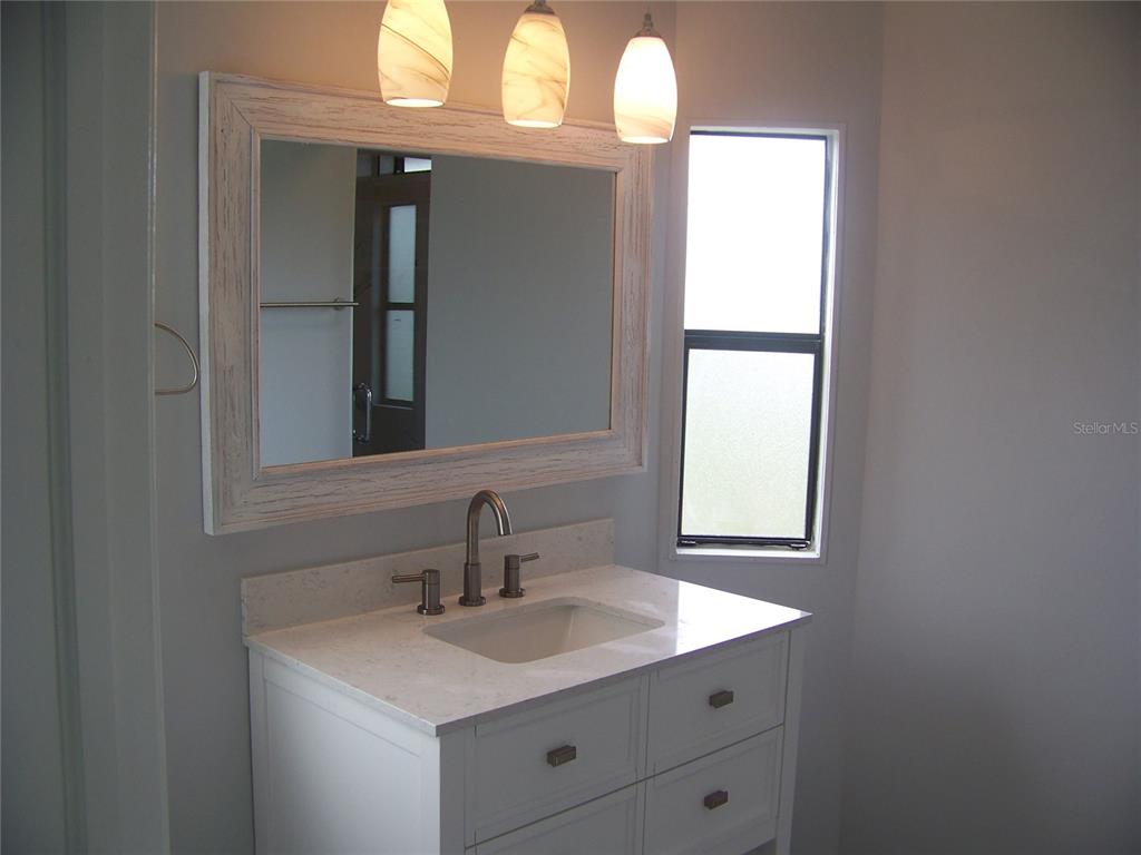 15550 Burnt Store Road, Unit 202 Punta Gorda, FL 33955 - Photo 37 of 61 a bathroom with a sink and a mirror