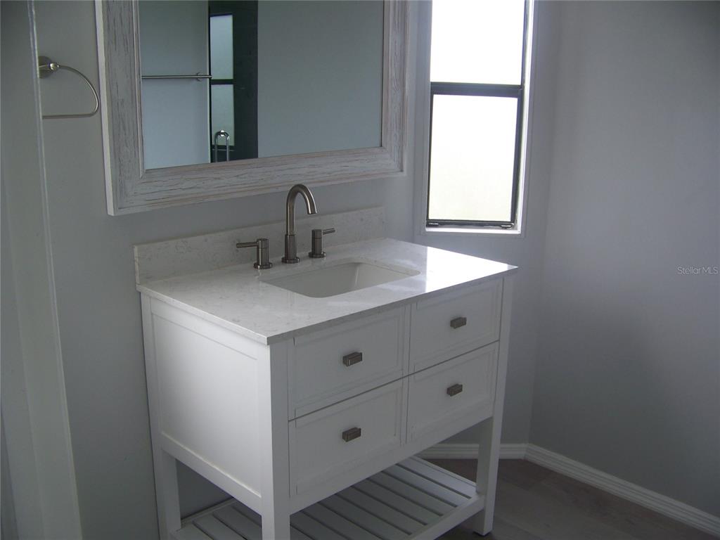 15550 Burnt Store Road, Unit 202 Punta Gorda, FL 33955 - Photo 38 of 61 a bathroom with a sink and a mirror