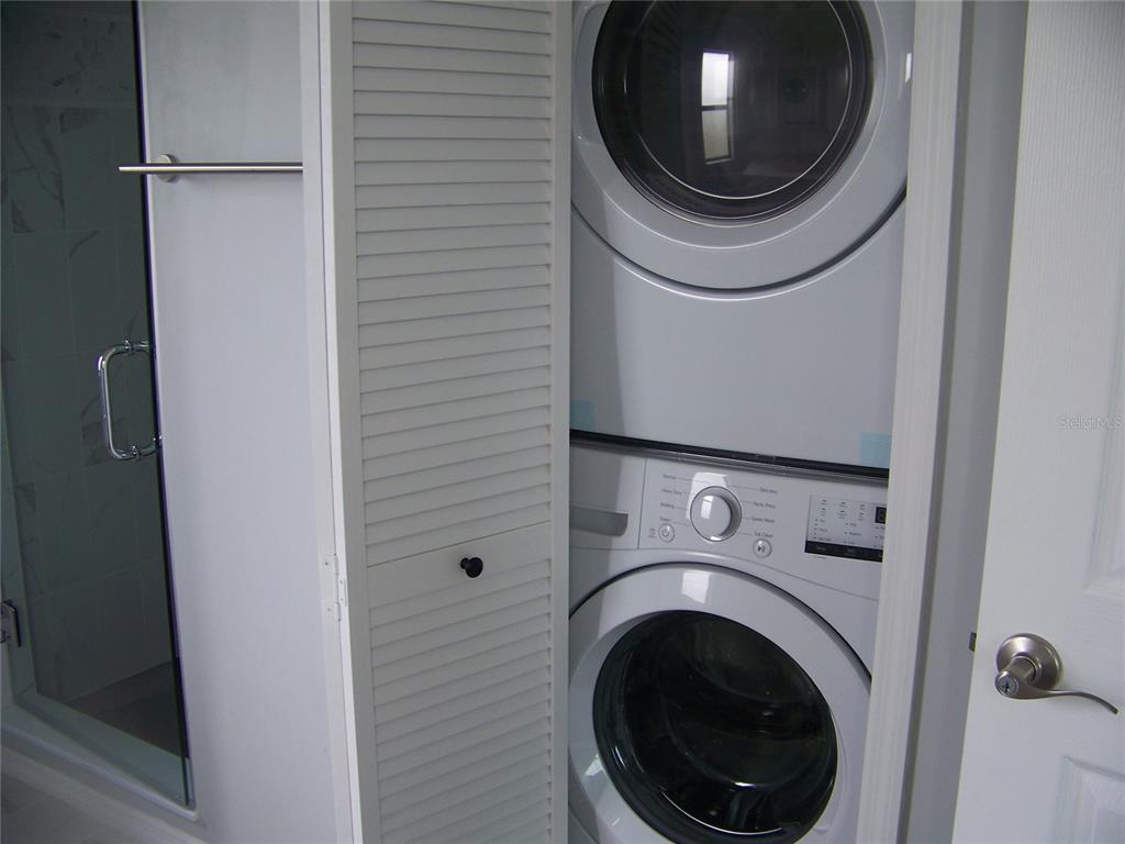 15550 Burnt Store Road, Unit 202 Punta Gorda, FL 33955 - Photo 40 of 61 a utility room with dryer and washer