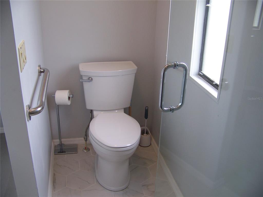 15550 Burnt Store Road, Unit 202 Punta Gorda, FL 33955 - Photo 44 of 61 a bathroom with a toilet and a shower