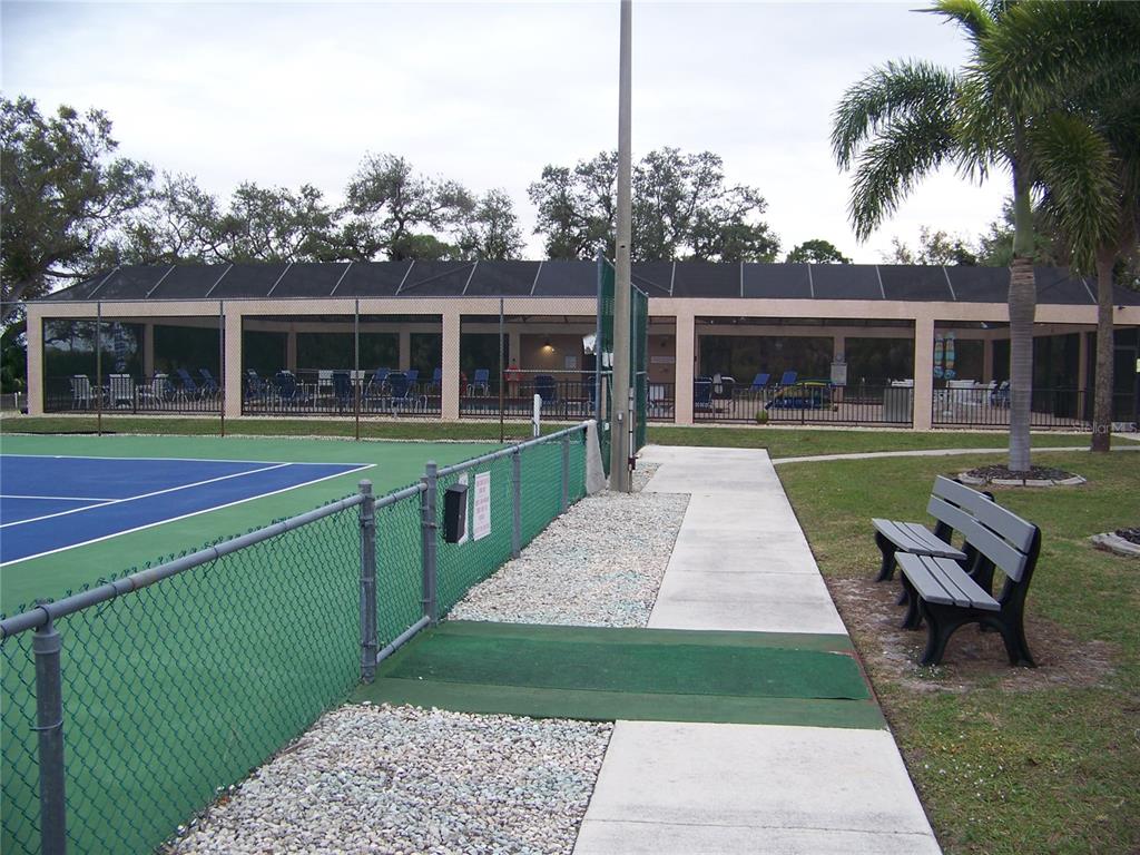 15550 Burnt Store Road, Unit 202 Punta Gorda, FL 33955 - Photo 55 of 61 a view of a house with a yard and sitting area