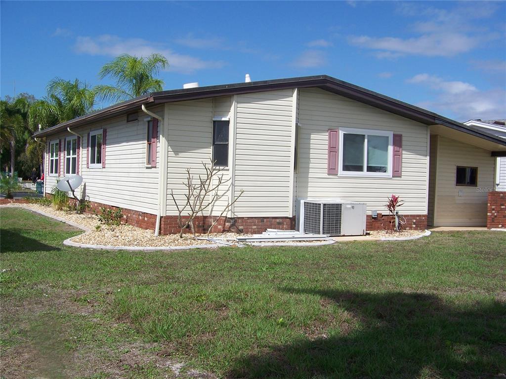 15550 Burnt Store Road, Unit 202 Punta Gorda, FL 33955 - Photo 7 of 61 a view of a house with a yard