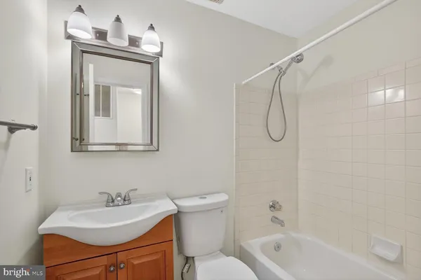 a bathroom with a sink vanity toilet and shower