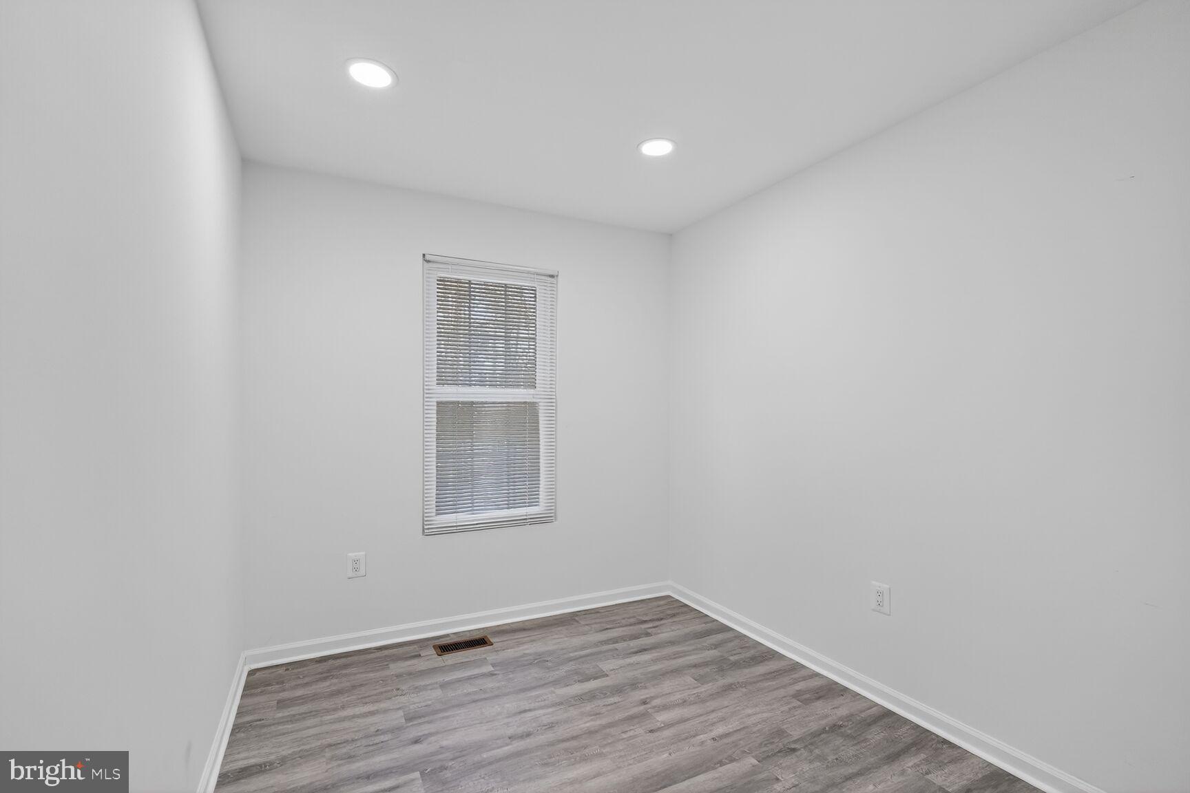 20415 Boulder Ridge Terrace Gaithersburg, MD 20882 - Photo 15 of 24 a view of an empty room with wooden floor and a window