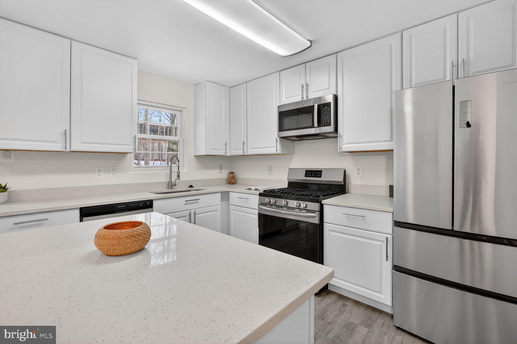 20415 Boulder Ridge Terrace Gaithersburg, MD 20882 - Photo 7 of 24 a kitchen with stainless steel appliances a refrigerator stove microwave and sink